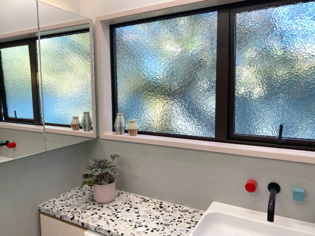 retro inspired bathroom with terrazzo counter top